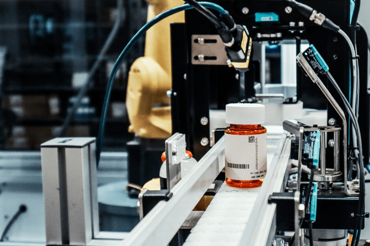 Automated central fill system conveying prescription bottle through pharmacy automation line