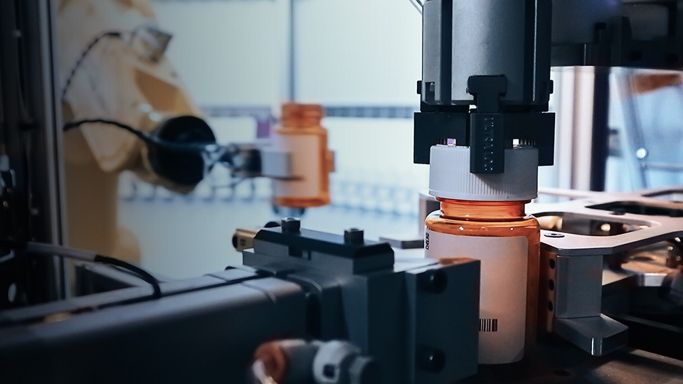Close up inside pod of bottle being capped